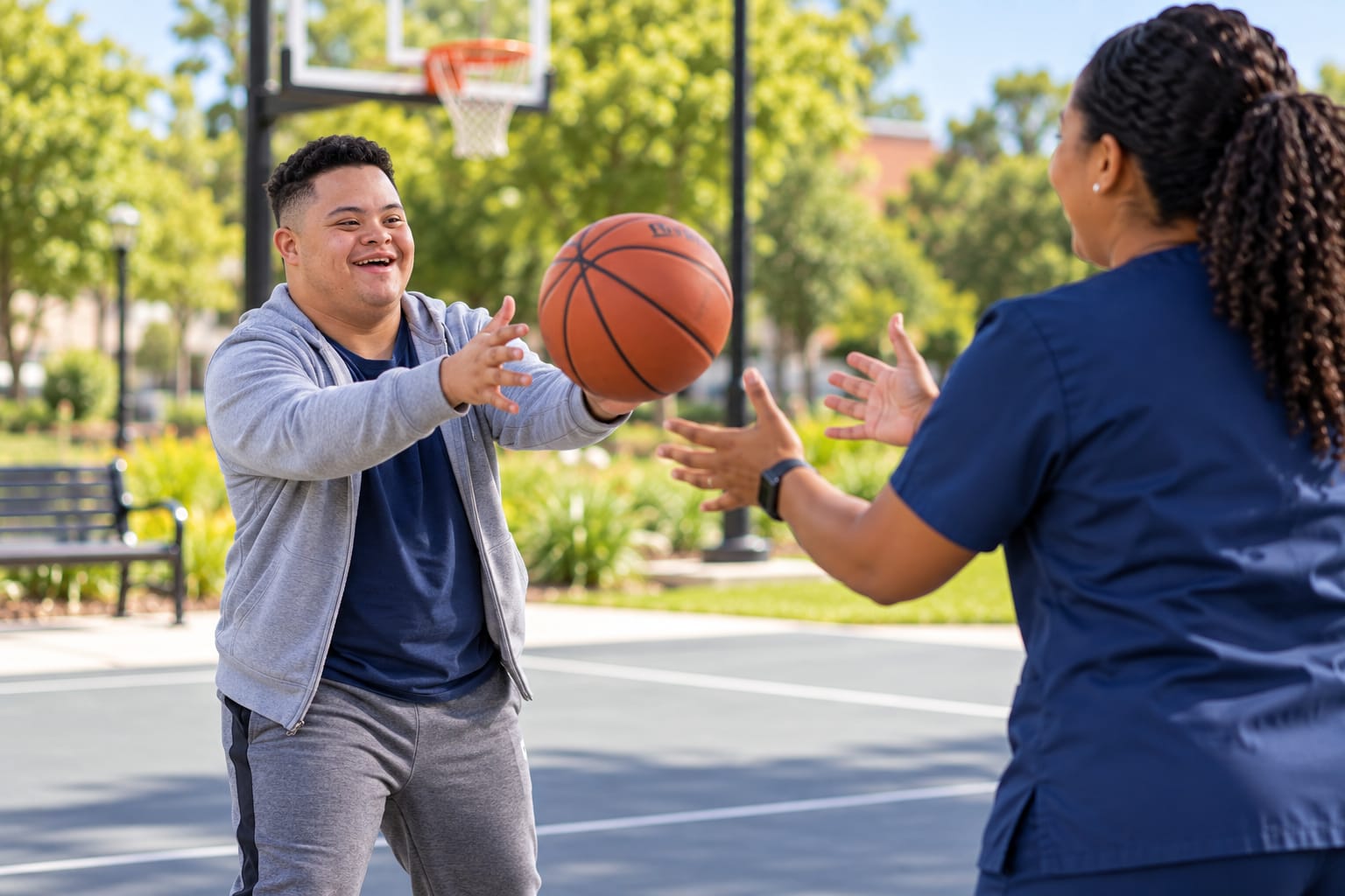 A man passing a basketball on an outdoor court while a support professional reaches for it.